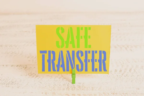 Text sign showing Safe Transfer. Conceptual photo Wire Transfers electronically Not paper based Transaction Green clothespin white wood background colored paper reminder office supply.