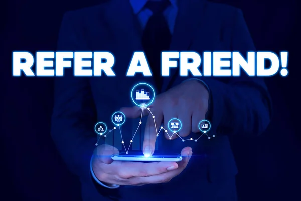 Writing note showing Refer A Friend. Business photo showcasing direct someone to another or send him something like gift Male wear formal suit presenting presentation smart device. — Stock Photo, Image