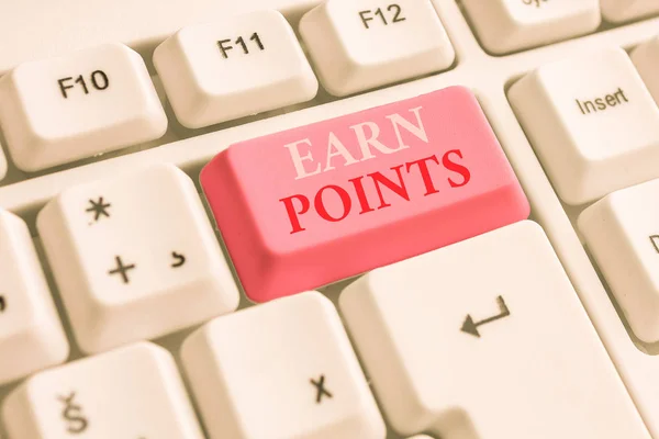 Text sign showing Earn Points. Conceptual photo getting praise or approval for something you have done White pc keyboard with empty note paper above white background key copy space.