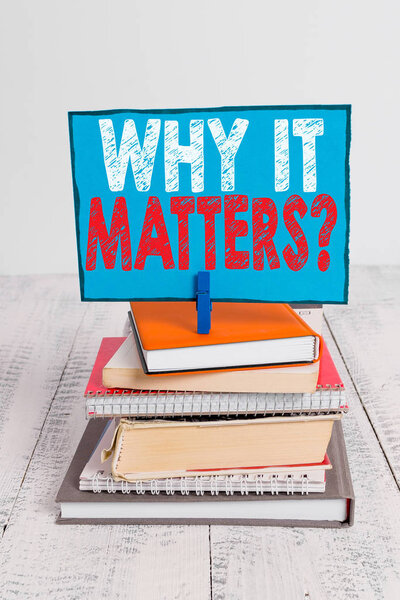 Writing note showing Why It Matters Question. Business photo showcasing most important thing to be done when involved in situation pile stacked books notebook pin color reminder white wooden.