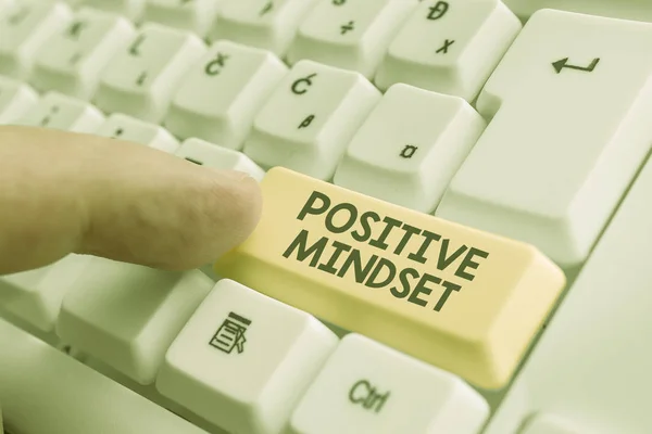 Writing note showing Positive Mindset. Business photo showcasing mental attitude in wich you expect favorable results White pc keyboard with note paper above the white background.