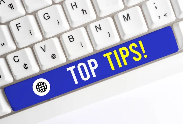 Writing note showing Top Tips. Business photo showcasing small but particularly useful piece of practical advice White pc keyboard with note paper above the white background.