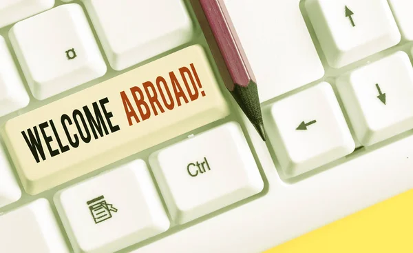Word writing text Welcome Abroad. Business concept for something that you say when someone gets on ship White pc keyboard with empty note paper above white background key copy space. Royalty Free Stock Photos