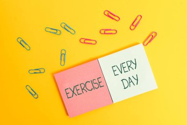 Her Gün Egzersiz gösteren not yazma. İş fotoğraf vitrin eve ve sağlıklı Renkli kare boş yapışkan not defterleri yaprak lar renk arka plan almak için enerjik vücut hareket.