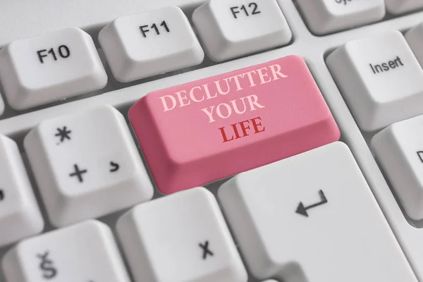 Text sign showing De Clutter Your Life. Conceptual photo remove unnecessary items from untidy or overcrowded places White pc keyboard with empty note paper above white background key copy space. — Stock Photo, Image