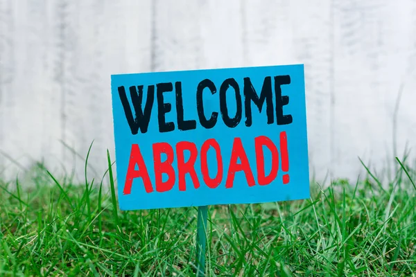 Handwriting text Welcome Abroad. Concept meaning something that you say when someone gets on ship Plain empty paper attached to a stick and placed in the green grassy land. — Stock Photo, Image