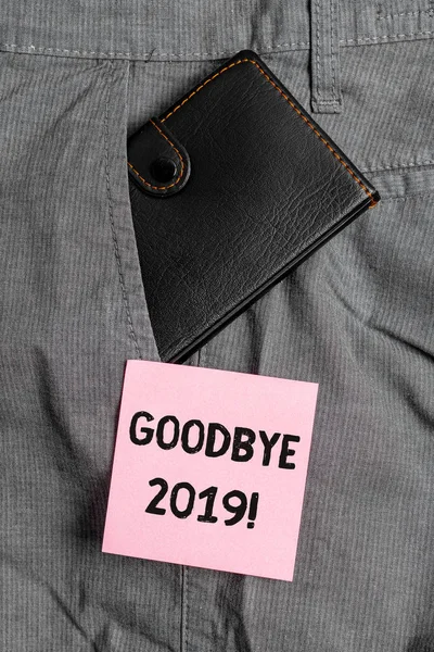 Conceptual hand writing showing Goodbye 2019. Business photo text express good wishes when parting or at the end of last year Small wallet inside trouser front pocket near notation paper.