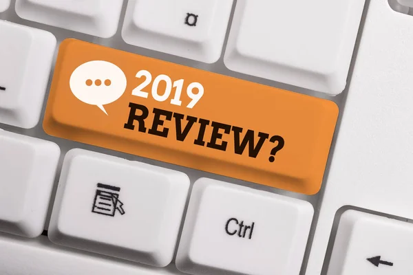 Text sign showing 2019 Review Question. Conceptual photo remembering past year events main actions or good shows White pc keyboard with empty note paper above white background key copy space.