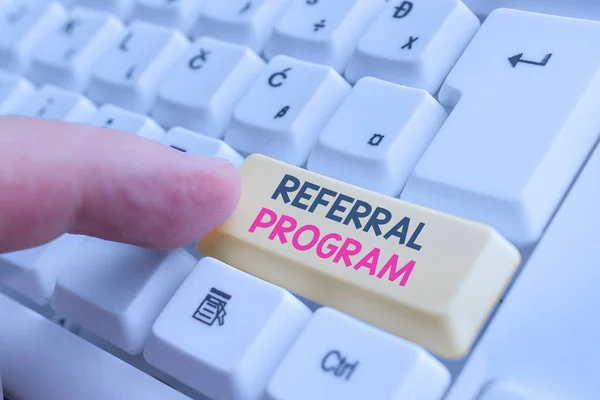 Writing note showing Referral Program. Business photo showcasing employees are rewarded for introducing suitable recruits White pc keyboard with note paper above the white background.