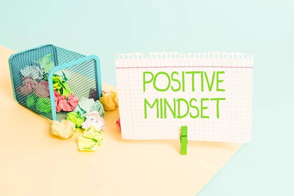 Text sign showing Positive Mindset. Conceptual photo mental attitude in wich you expect favorable results Trash bin crumpled paper clothespin empty reminder office supplies tipped.