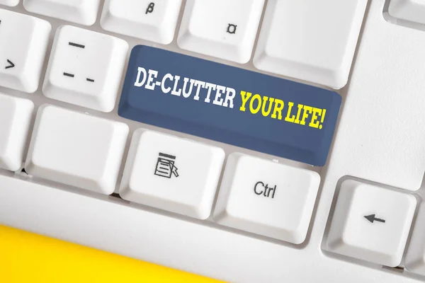 Word writing text De Clutter Your Life. Business concept for remove unnecessary items from untidy or overcrowded places White pc keyboard with empty note paper above white background key copy space. — Stock Photo, Image