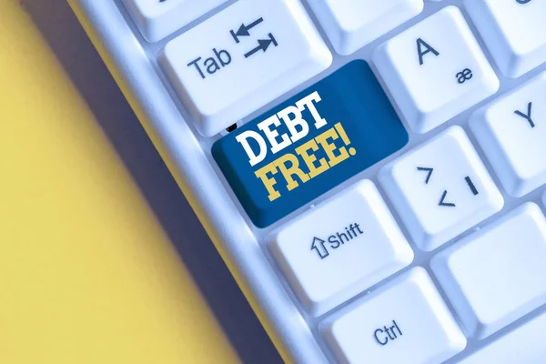 Conceptual hand writing showing Debt Free. Business photo showcasing does not owning any money or things to any individual or companies White pc keyboard with note paper above the white background. — Stock Photo, Image