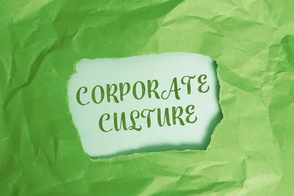 Text sign showing Corporate Culture. Conceptual photo pervasive values and attitudes that characterize a company Green crumpled ripped colored paper sheet centre torn colorful background.
