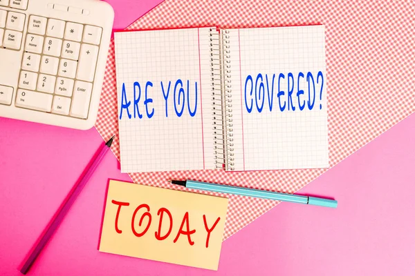Text sign showing Are You Covered Question. Conceptual photo asking showing if they had insurance in work or life Writing equipments and computer stuffs placed above colored plain table. — Stock Fotó