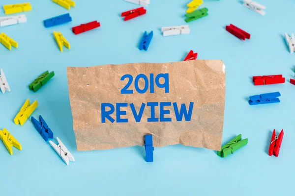 Text sign showing 2019 Review. Conceptual photo New trends and prospects in tourism or services for 2019 Colored clothespin papers empty reminder blue floor background office pin.