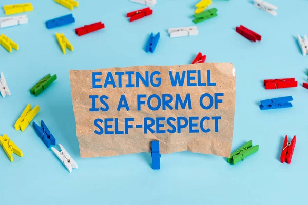 Text sign showing Eating Well Is A Form Of Self Respect. Conceptual photo a quote of promoting healthy lifestyle Colored clothespin papers empty reminder blue floor background office pin.