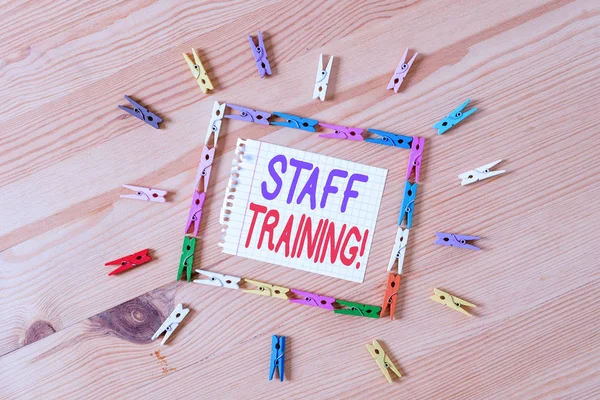Handwriting text writing Staff Training. Concept meaning learn specific knowledge improve perforanalysisce in current roles Colored clothespin papers empty reminder wooden floor background office.