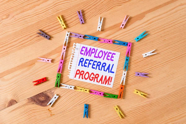 Handwriting text writing Employee Referral Program. Concept meaning internal recruitment method employed by organizations Colored clothespin papers empty reminder wooden floor background office.