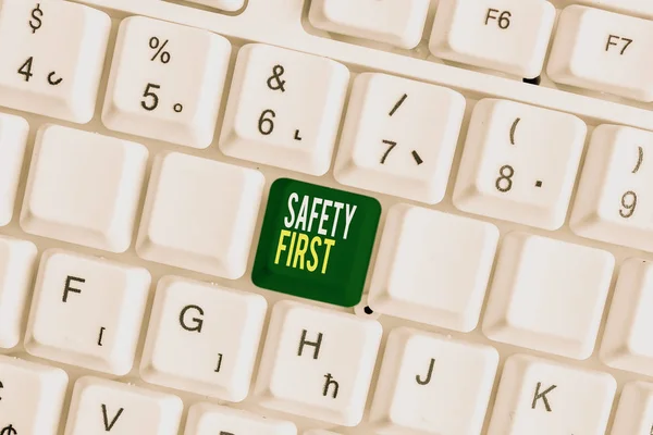 Handwriting text Safety First. Concept meaning Avoid any unnecessary risk Live Safely Be Careful Pay attention White pc keyboard with empty note paper above white background key copy space. — Stock Photo, Image