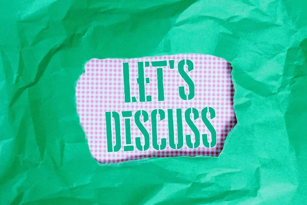 Text sign showing Let S Discuss. Conceptual photo Permit to Talk Open Up Go Over a Topic Chat Sharing Green crumpled ripped colored paper sheet centre torn colorful background.