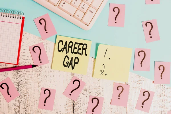 Conceptual hand writing showing Career Gap. Business photo text A scene where in you stop working by your profession for a while Writing tools and scribbled paper on top of the wooden table.