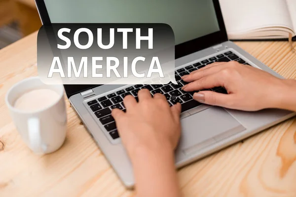 Text sign showing South America. Conceptual photo Continent in Western Hemisphere Latinos known for Carnivals woman laptop computer smartphone mug office supplies technological devices. — Stock Photo, Image