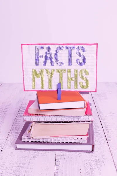 Word writing text Facts Myths. Business concept for work based on imagination rather than on real life difference pile stacked books notebook pin clothespin colored reminder white wooden. — Stock Photo, Image