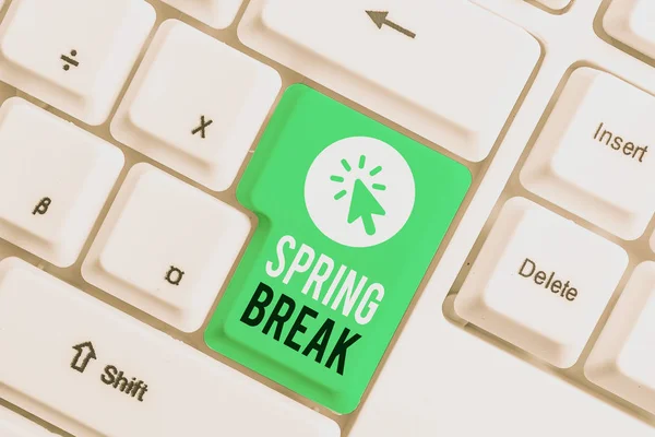 Writing note showing Spring Break. Business photo showcasing Vacation period at school and universities during spring White pc keyboard with note paper above the white background.