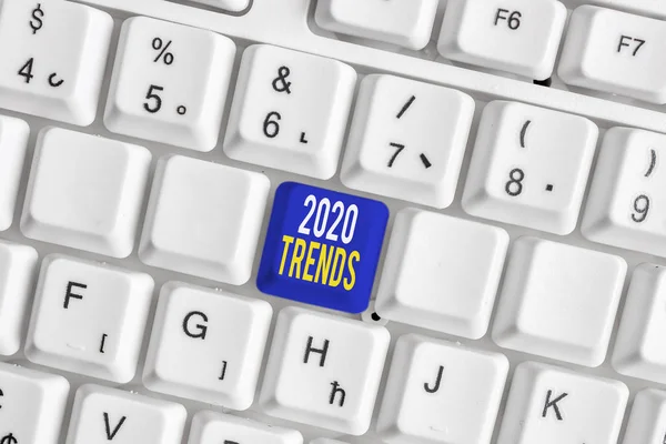 Conceptual hand writing showing 2020 Trends. Business photo text things that is famous for short period of time in current year White pc keyboard with note paper above the white background. — Stock Fotó