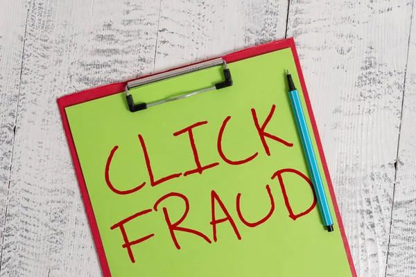 Handwriting text Click Fraud. Concept meaning practice of repeatedly clicking on advertisement hosted website Colored clipboard blank paper sheet marker old wooden vintage background.