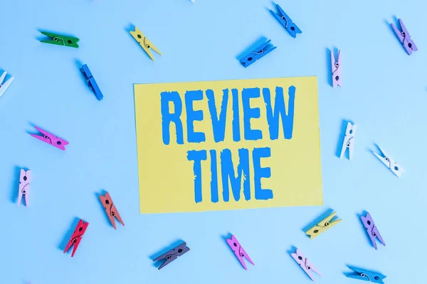 Handwriting text Review Time. Concept meaning situation or system its formal examination by showing authority Colored clothespin rectangle shaped reminder paper light blue background. — Stock Photo, Image