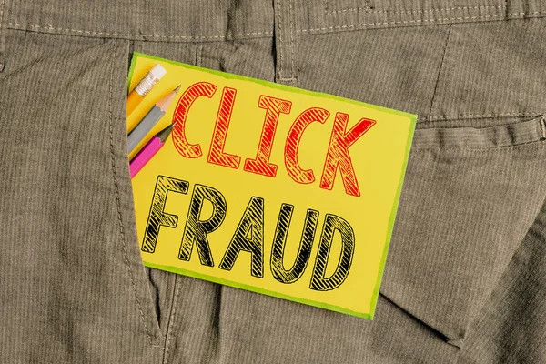 Handwriting text writing Click Fraud. Concept meaning practice of repeatedly clicking on advertisement hosted website Writing equipment and yellow note paper inside pocket of man work trousers.