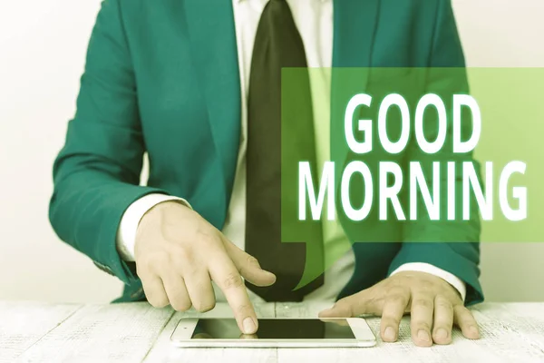 Conceptual hand writing showing Good Morning. Business photo showcasing A conventional expression at meeting or parting in the morning Businessman in blue suite with a tie holds lap top in hands. — Stockfoto