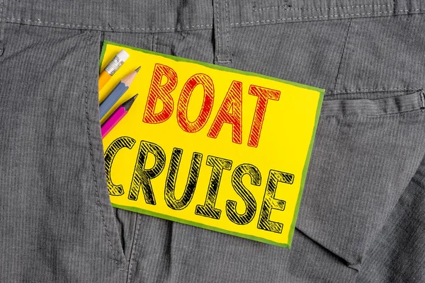 Handwriting text writing Boat Cruise. Concept meaning sail about in area without precise destination with large ship Writing equipment and yellow note paper inside pocket of man work trousers.