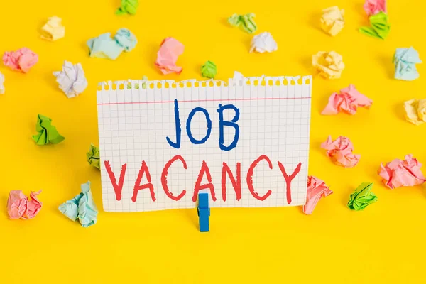 Word writing text Job Vacancy. Business concept for empty or available paid place in small or big company Colored crumpled papers empty reminder white floor background clothespin.