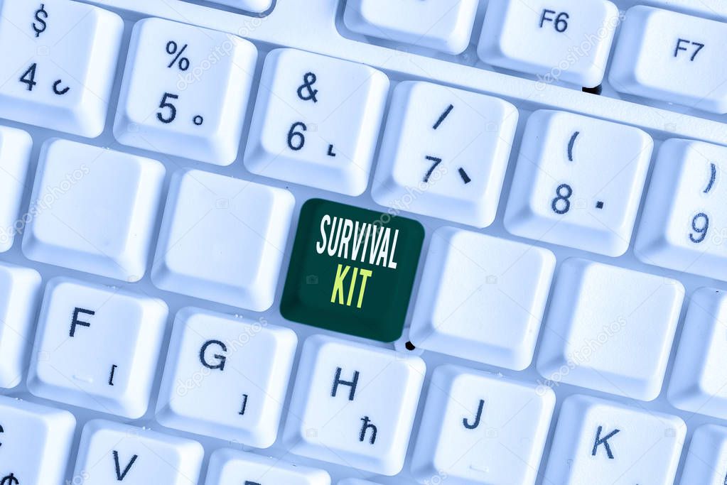 Handwriting text Survival Kit. Concept meaning Emergency Equipment Collection of items to help someone White pc keyboard with empty note paper above white background key copy space.