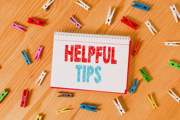 Conceptual hand writing showing Helpful Tips. Business photo text Useful secret Information Advice given to accomplish something Colored crumpled papers wooden floor background clothespin. — Stock Photo, Image