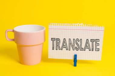 Writing note showing Translate. Business photo showcasing Another word with same equivalent meaning of a target language Cup empty paper blue clothespin rectangle shaped reminder yellow office. clipart