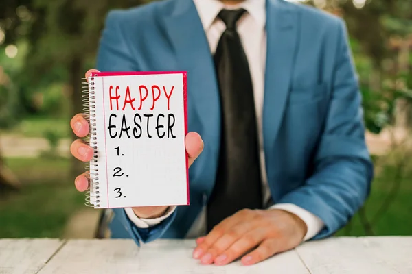 Text sign showing Happy Easter. Conceptual photo Christian feast commemorating the resurrection of Jesus Man holds empty paper with copy space in front of him.