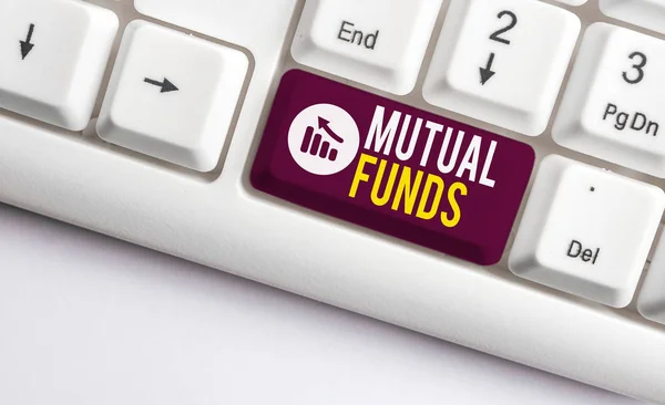 Writing note showing Mutual Funds. Business photo showcasing An investment program funded by shareholders Individual Stocks White pc keyboard with note paper above the white background.
