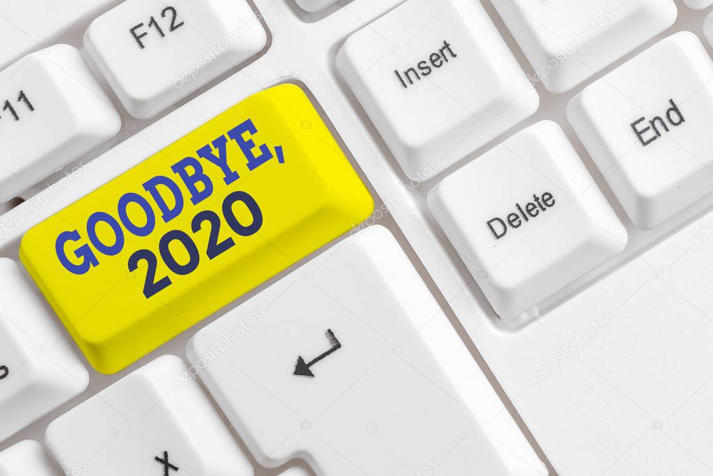 Handwriting text Goodbye 2020. Concept meaning New Year Eve Milestone Last Month Celebration Transition White pc keyboard with empty note paper above white background key copy space.