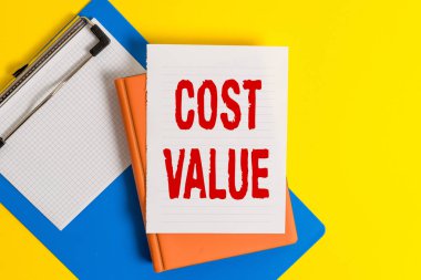 Kelime yazma metni Maliyet Değeri. Satın aldığınız bir öğe için olağan olarak ödenen veya masada kopya alanı olan boş kağıt yığınını işe alan miktar için iş kavramı.