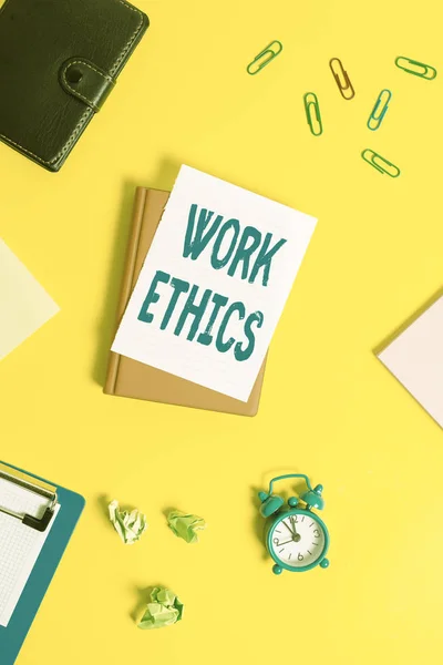 Text sign showing Work Ethics. Conceptual photo A set of values centered on the importance of doing work Pile of empty papers with copy space on the table.