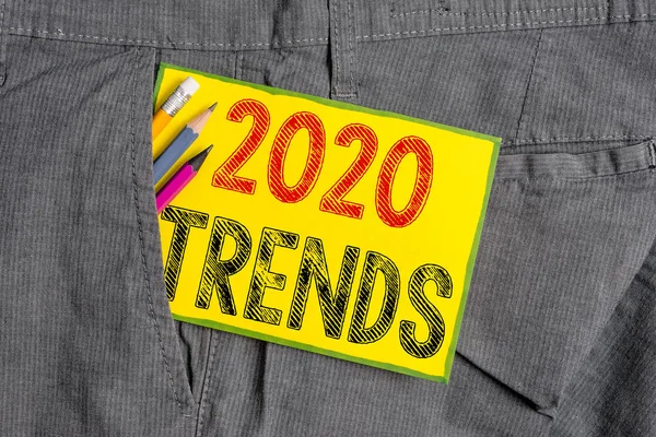 Handwriting text writing 2020 Trends. Concept meaning things that is famous for short period of time in current year Writing equipment and yellow note paper inside pocket of man work trousers.