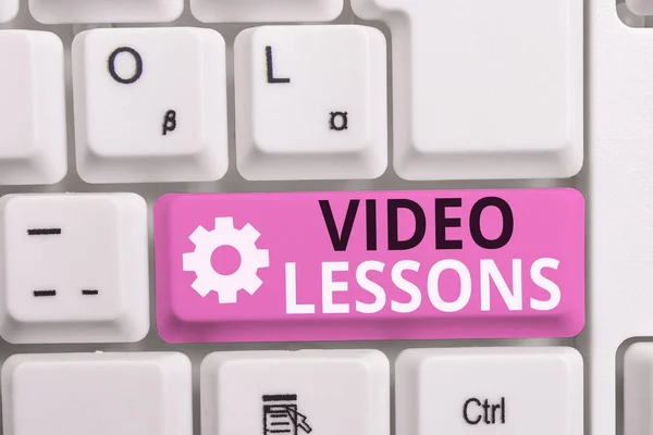 Writing note showing Video Lessons. Business photo showcasing Online Education material for a topic Viewing and learning White pc keyboard with note paper above the white background.