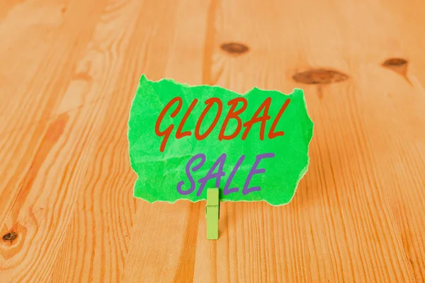 Text sign showing Global Sale. Conceptual photo analysisagers operations for companies do business internationally Empty reminder wooden floor background green clothespin groove slot office.