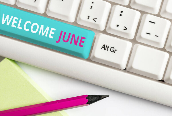 Handwriting text Welcome June. Concept meaning Calendar Sixth Month Second Quarter Thirty days Greetings White pc keyboard with empty note paper above white background key copy space.