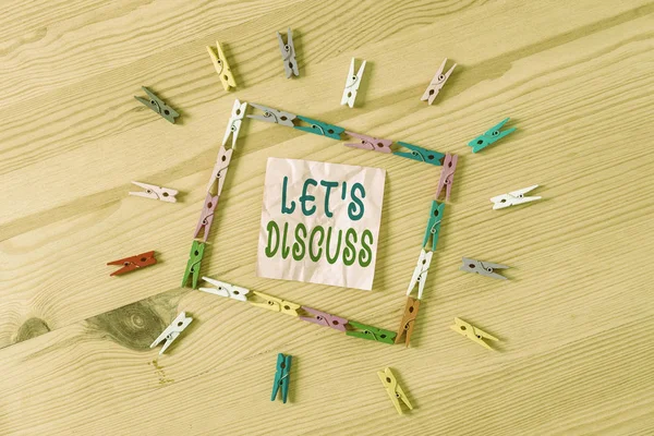 Text sign showing Let S Discuss. Conceptual photo Permit to Talk Open Up Go Over a Topic Chat Sharing Colored clothespin papers empty reminder wooden floor background office.