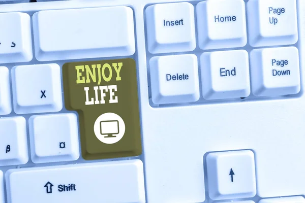 Signo de texto que muestra Enjoy Life. Foto conceptual Cualquier cosa, lugar, comida o demostración, que te hace relajarte y feliz Teclado de PC blanco con papel de nota vacío sobre el espacio de copia de la tecla de fondo blanco . — Foto de Stock