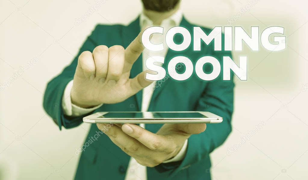 Word writing text Coming Soon. Business concept for something is going to happen in really short time of period Businessman with pointing finger in front of him.